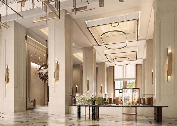 A spacious lobby with high ceilings, large columns, and a central table with floral arrangements. - Waldorf Astoria Kuala Lumpur (Kuala Lumpur)