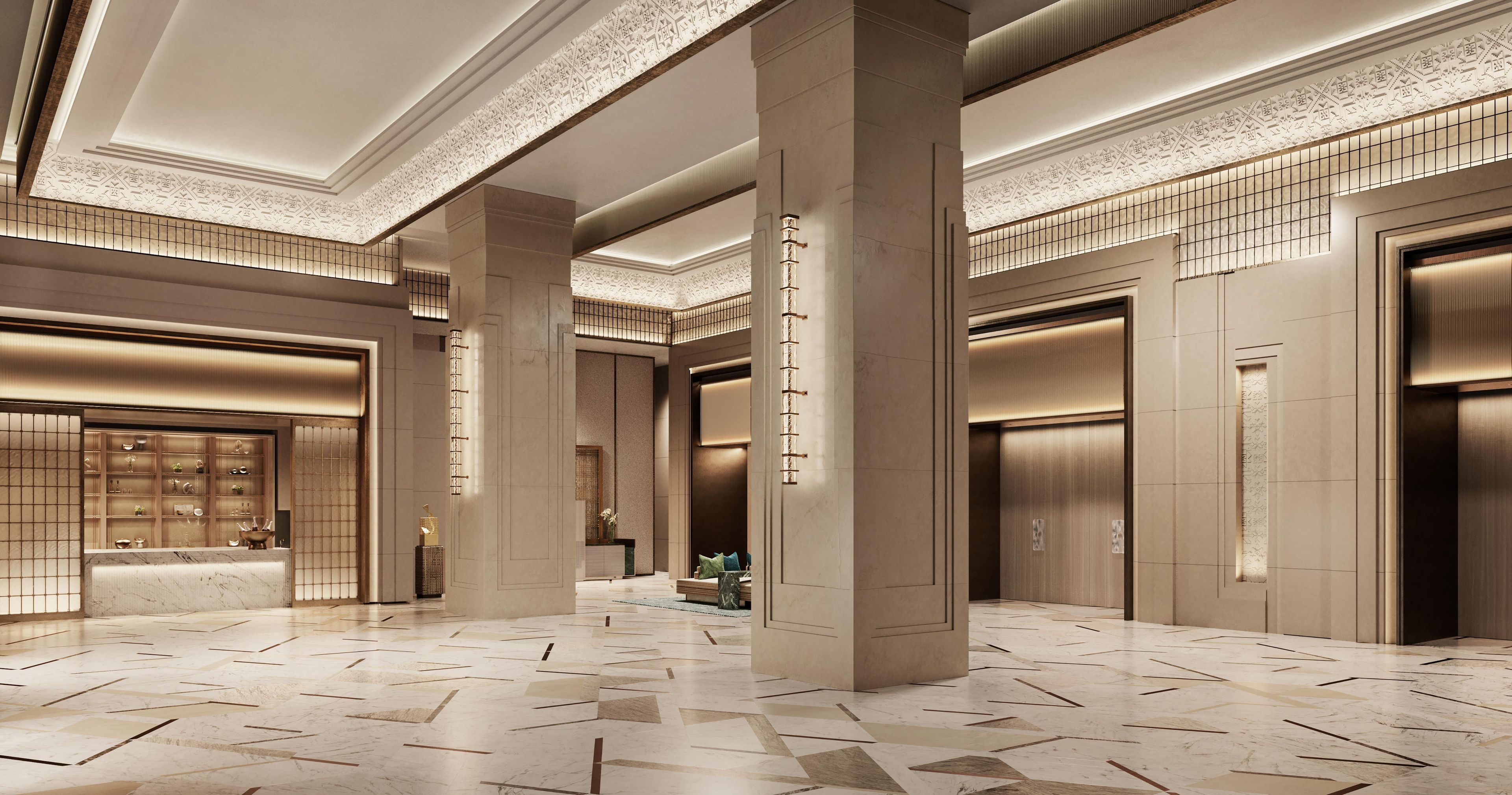 A spacious lobby with a patterned floor, large columns, and a reception area with a counter.