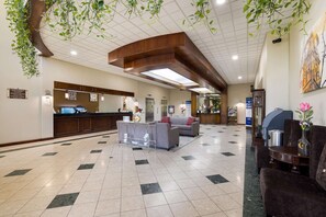 Welcome to our lobby, featuring a reception desk, comfortable seating area, and beautiful artwork.