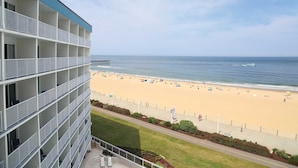A hotel with multiple balconies overlooking a beach. - Surfbreak Virginia Beach Oceanfront, an Ascend Collection Hotel (Virginia Beach)