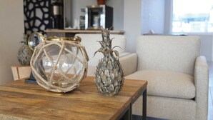 A wooden table with two decorative glass vases and a mirror. - Surfbreak Virginia Beach Oceanfront, an Ascend Collection Hotel (Virginia Beach)