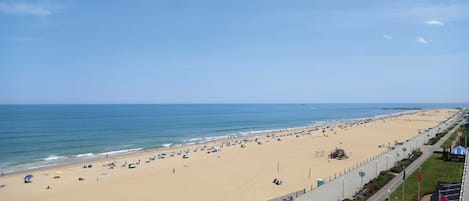 On the beach, white sand, beach cabanas, sun loungers