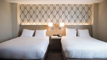 Premium bedding, desk, laptop workspace, blackout drapes