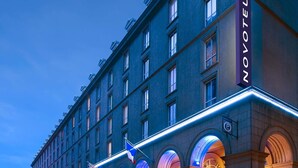 A hotel building with a prominent 'NOVOMATEL' sign, multiple windows, and a series of arches at the ground level. - Novotel Toronto Centre (Toronto)