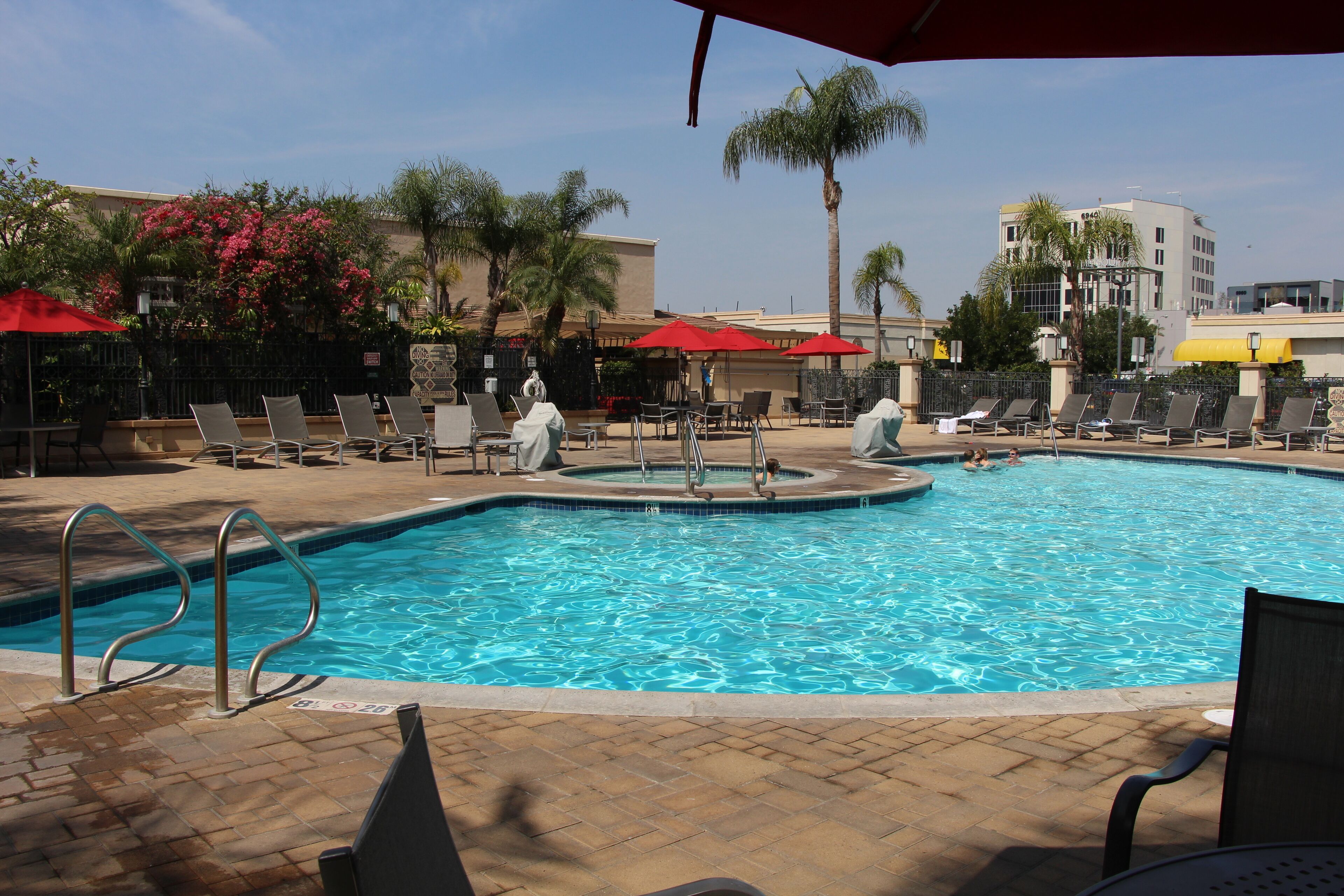 outdoor pool, open 7:00 am to 10:00 pm, pool umbrellas, pool loungers