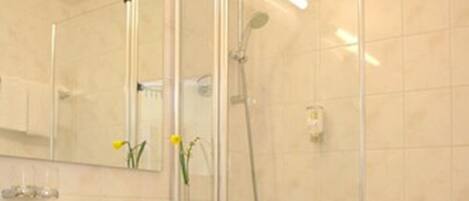 A modern bathroom with a toilet, sink, and shower.