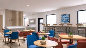 A modern hotel lobby with multiple seating areas, a coffee bar, and large windows. - Days Inn by Wyndham Encinitas Moonlight Beach (Encinitas)