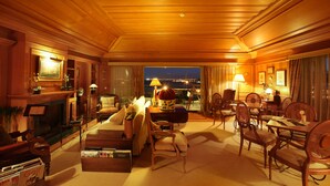 A well-lit, elegantly furnished room with a fireplace, comfortable seating, and a view of the city at night. - As Janelas Verdes Inn, a Lisbon Heritage Collection (Lisbon)