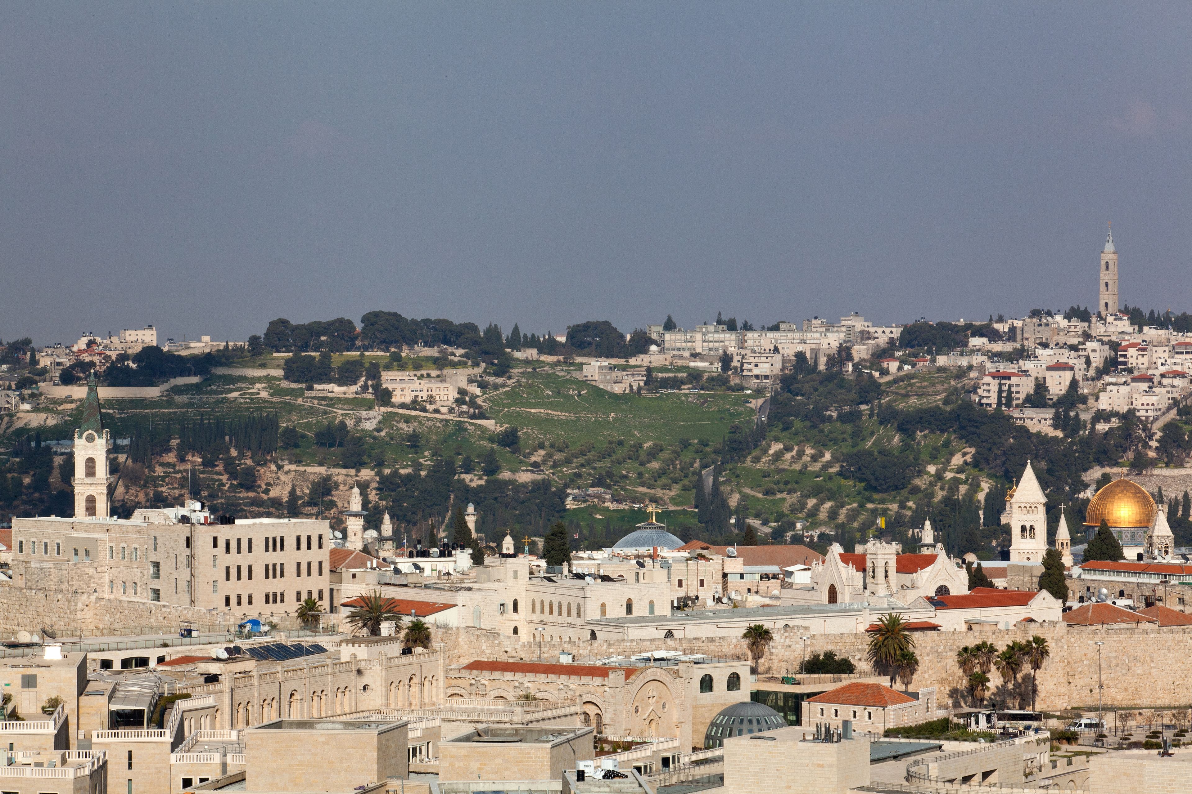 A historic cityscape with prominent religious structures, including a dome and a tower.