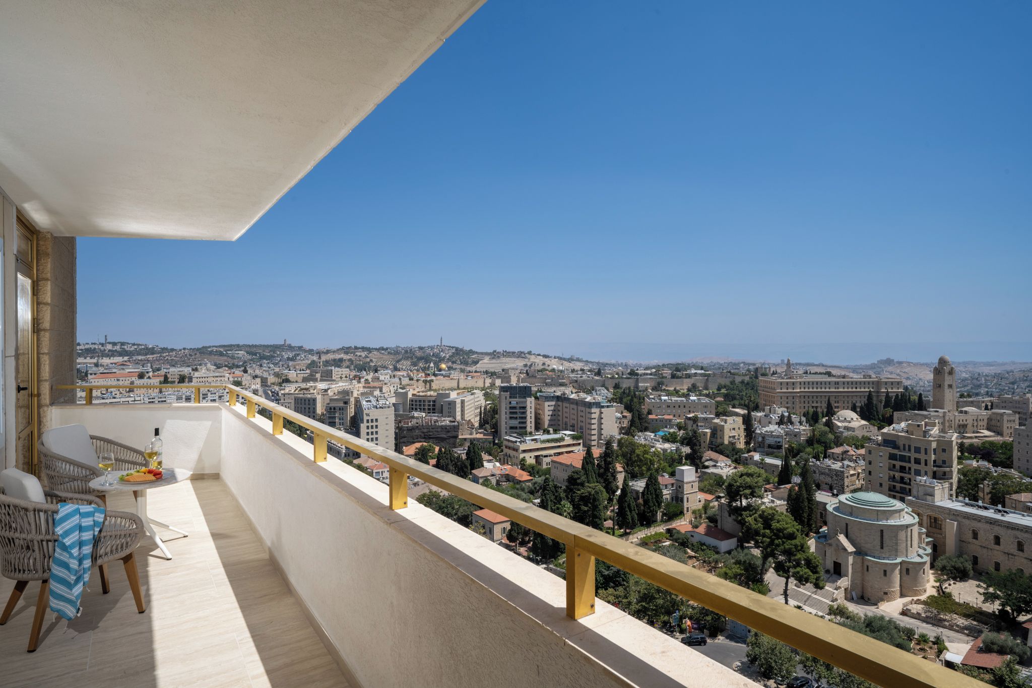 Un balcon offrant une vue sur le paysage urbain, avec des bâtiments et une mosquée.