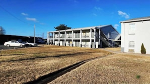 A two-story motel with a flat roof and a covered parking area.