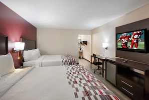 A hotel room with two beds, a desk, a television, and a minibar. - Red Roof Inn Dillon, SC (Dillon)