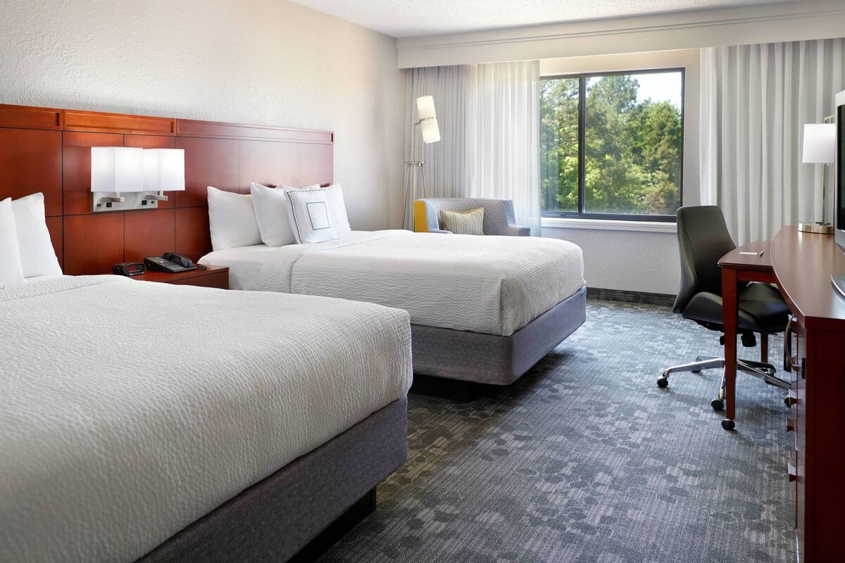 hypo-allergenic bedding, desk, laptop workspace, blackout curtains