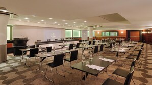 A conference room with multiple tables and chairs, equipped with water bottles and papers, in a hotel setting. - Hotel Dei Cavalieri Milano Duomo (Milan)