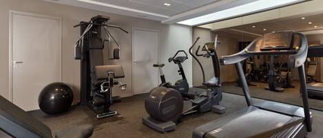 A gym with treadmills, elliptical machines, a stationary bike, and a rowing machine.