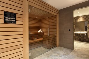 A modern bathroom with a wooden sauna, a glass-enclosed shower, and a sink area. - Hôtel Auteuil Tour Eiffel (Paris)