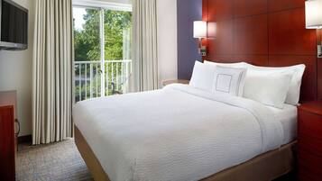 Premium bedding, desk, laptop workspace, blackout drapes