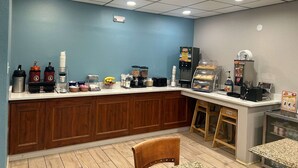 A breakfast bar with coffee machines, a fruit basket, and a cereal dispenser. - Days Inn by Wyndham Killeen Fort Hood (Killeen)