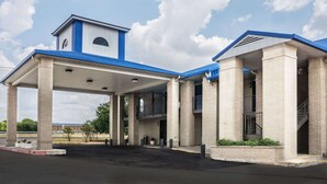 A gas station with a blue and white color scheme, featuring a covered area with columns and a small tower-like structure on the roof. - Days Inn by Wyndham Killeen Fort Hood (Killeen)