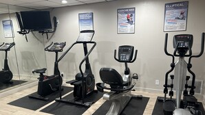 A gym with various exercise machines, including treadmills and elliptical trainers, arranged on mats. - Days Inn by Wyndham Killeen Fort Hood (Killeen)