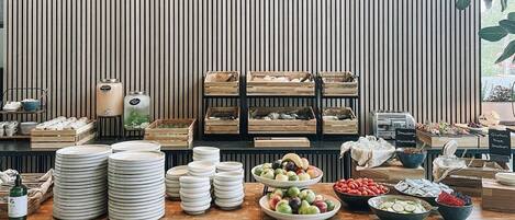 A buffet setup with various food items and dishes.