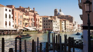 A canal with boats, historic buildings, and a prominent dome structure. - CHC Continental, BW Premier Collection (Venice)