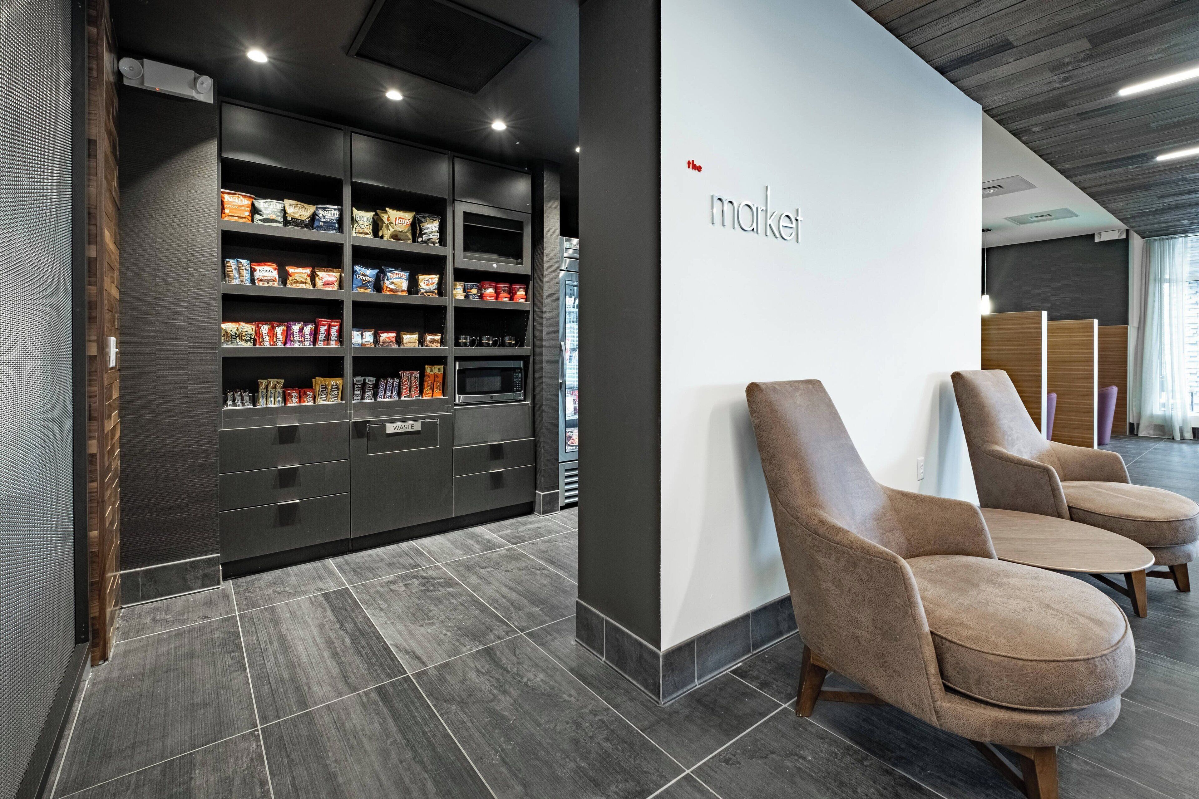 A modern interior with a reception area, a snack bar, and seating.