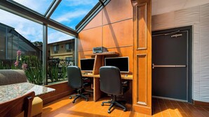 A modern office space with two desks, chairs, and a small table. - Best Western Detroit Livonia (Livonia)