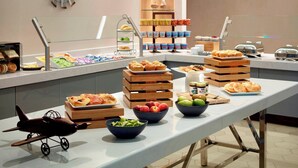 A buffet setup with various food items and a decorative airplane model. - Marriott at the University of Dayton (Dayton)