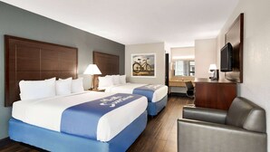 A hotel room with two beds, a desk, a chair, a TV, and a painting on the wall. - Days Inn by Wyndham Rock Hill (Rock Hill)