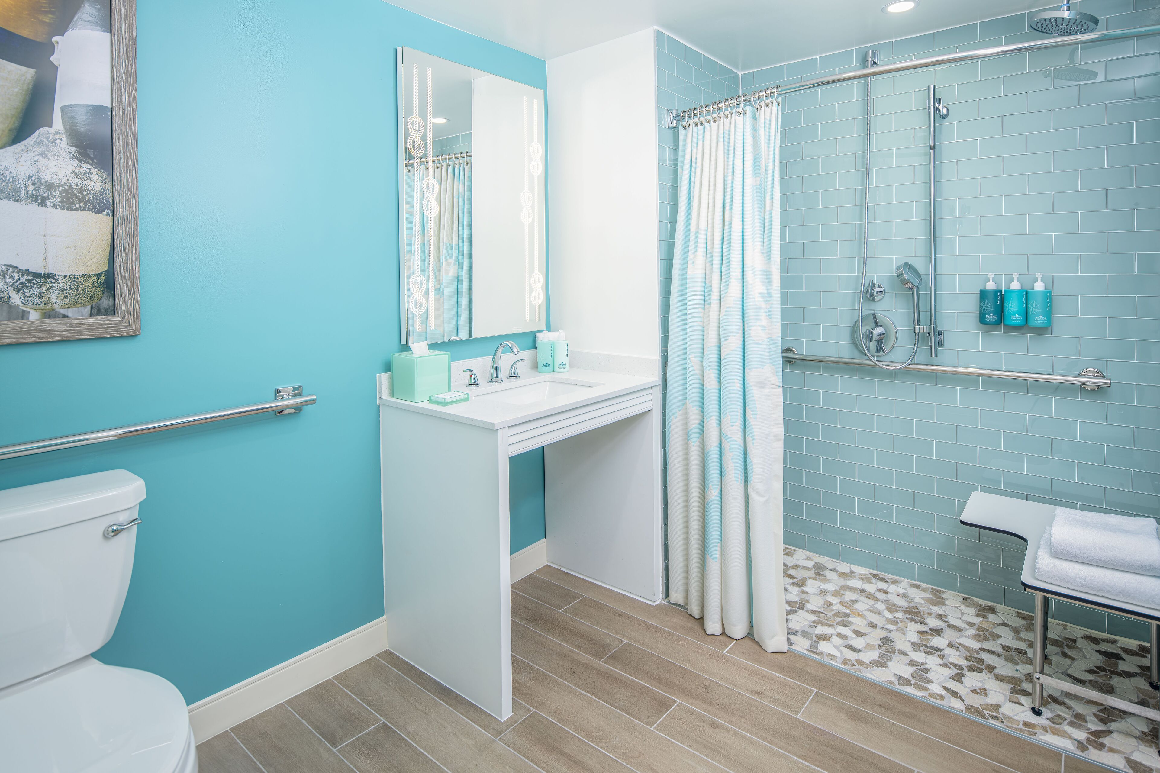 A bathroom with a toilet, sink, and shower area.