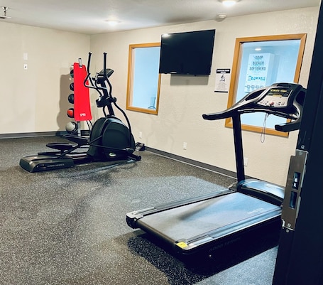A fitness room with treadmills, an elliptical, and a stationary bike.. Days Inn by Wyndham Wall