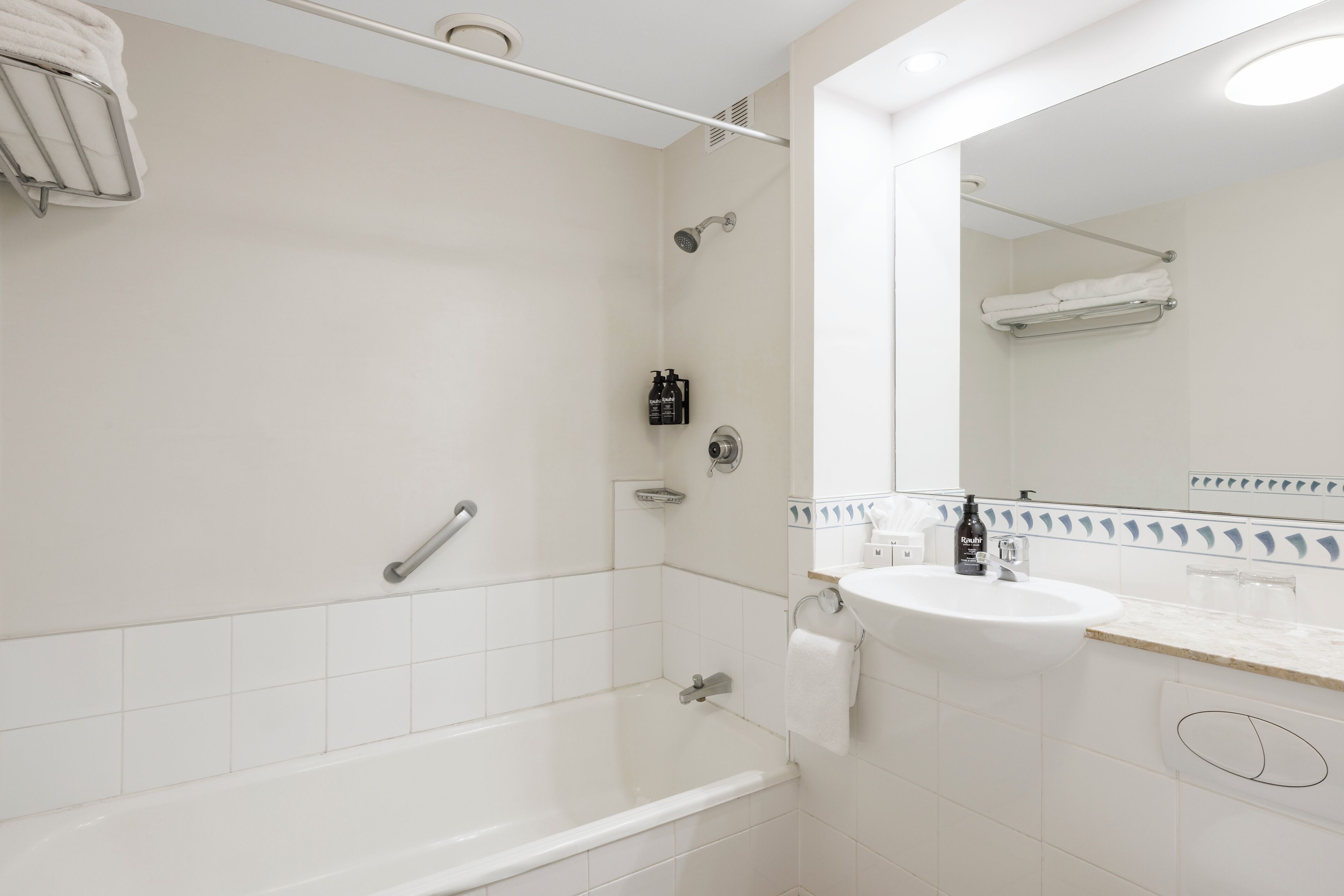 A modern bathroom with a bathtub, a sink, and a shower.