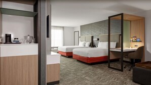 A hotel room with two beds, a desk, and a kitchenette. - SpringHill Suites by Marriott Beaufort (Beaufort)