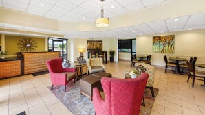 A spacious lobby with a reception desk, seating area, and dining tables. - Best Western Dayton (Dayton)