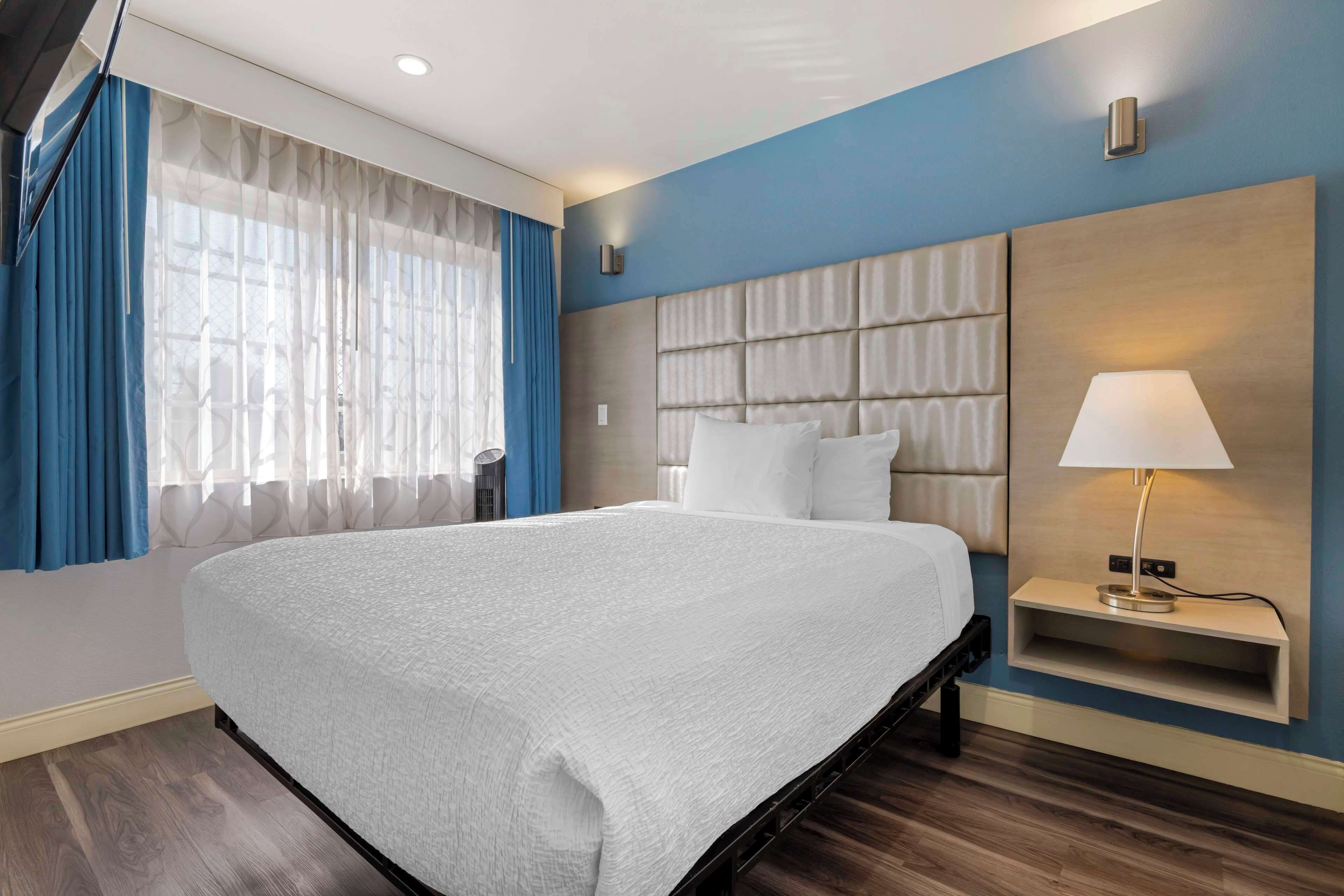 pillow-top beds, desk, laptop workspace, blackout curtains