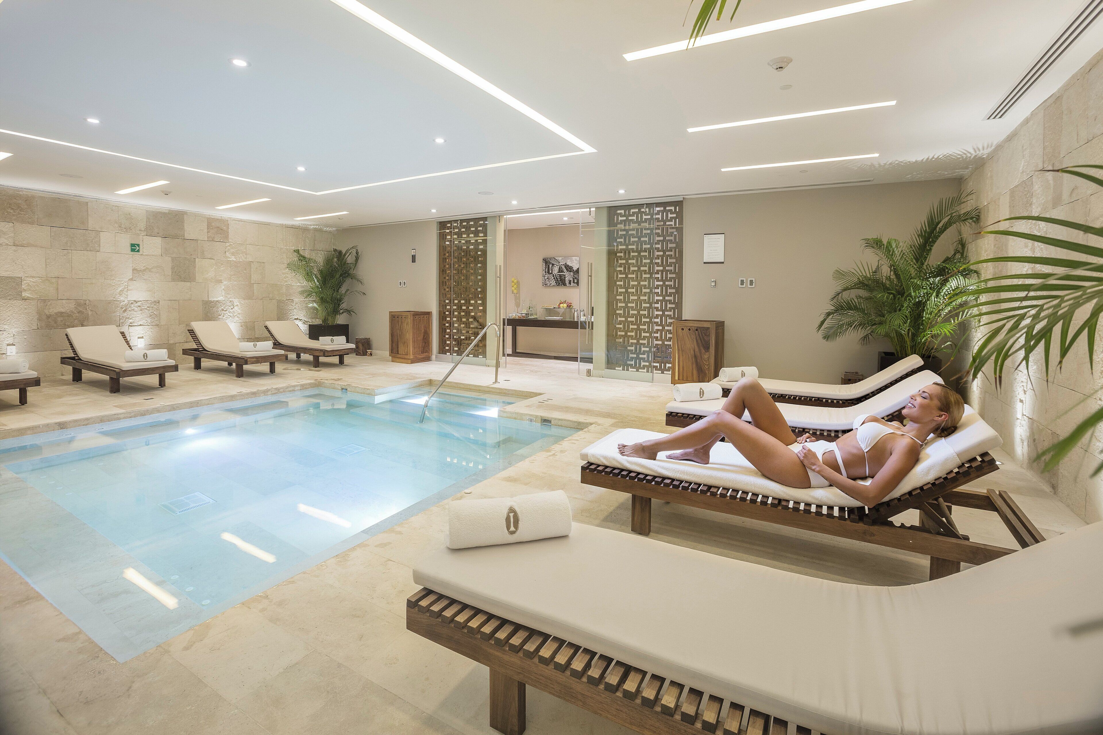 A poolside area with lounge chairs and a pool.