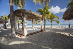 On the beach, white sand, beach umbrellas, beach towels