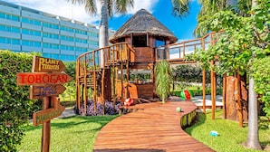 A wooden deck leading to a thatched-roof hut with a wooden staircase. - InterContinental Presidente Cancun Resort by IHG (Cancun)