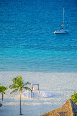 On the beach, white sand, beach umbrellas, beach towels