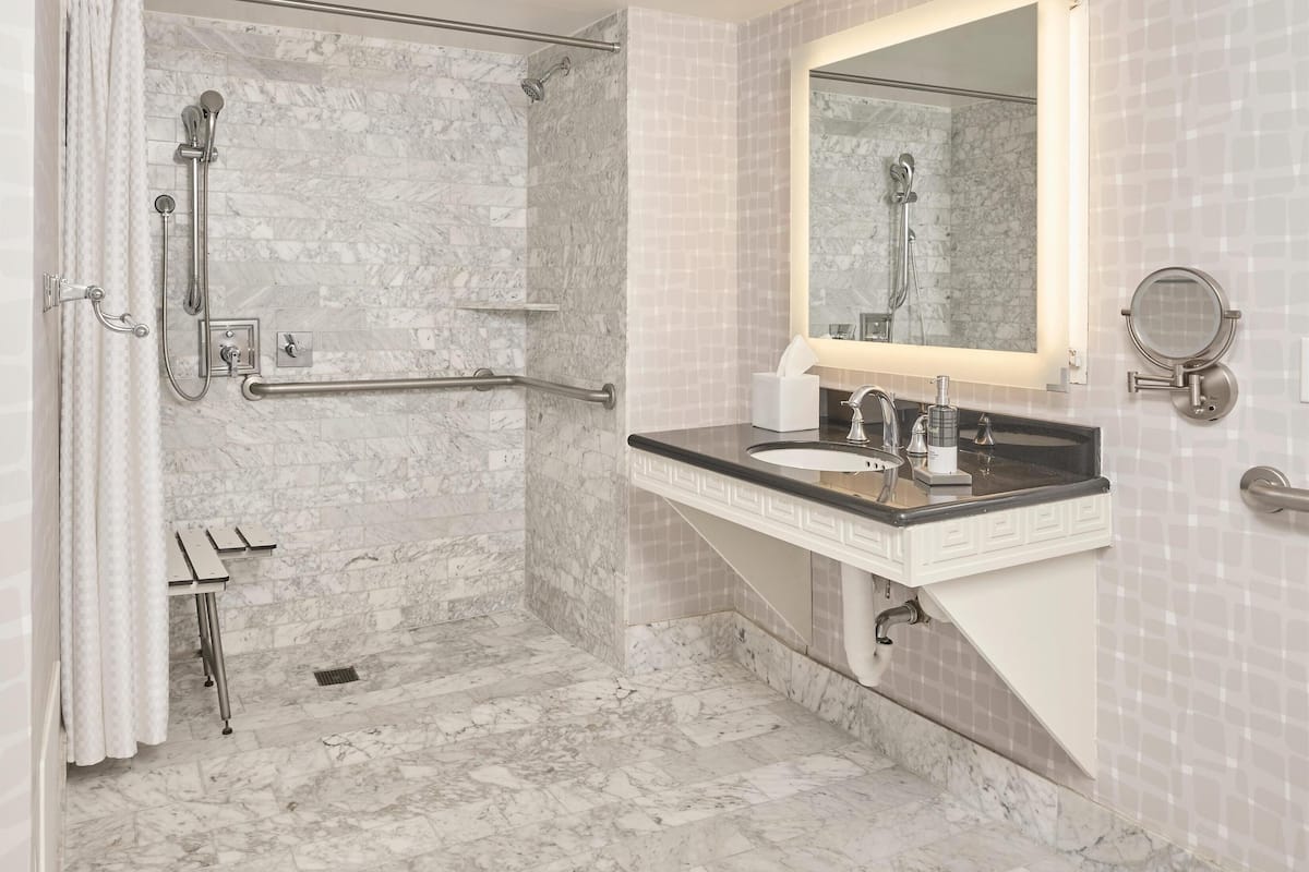 suite, 1 queen bed, roll-in shower, balcony | bathroom | combined shower/bathtub, free toiletries, hair dryer, towels