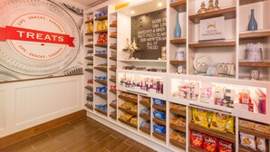 A hotel lobby with a 'Treats' section featuring snacks and sundries.