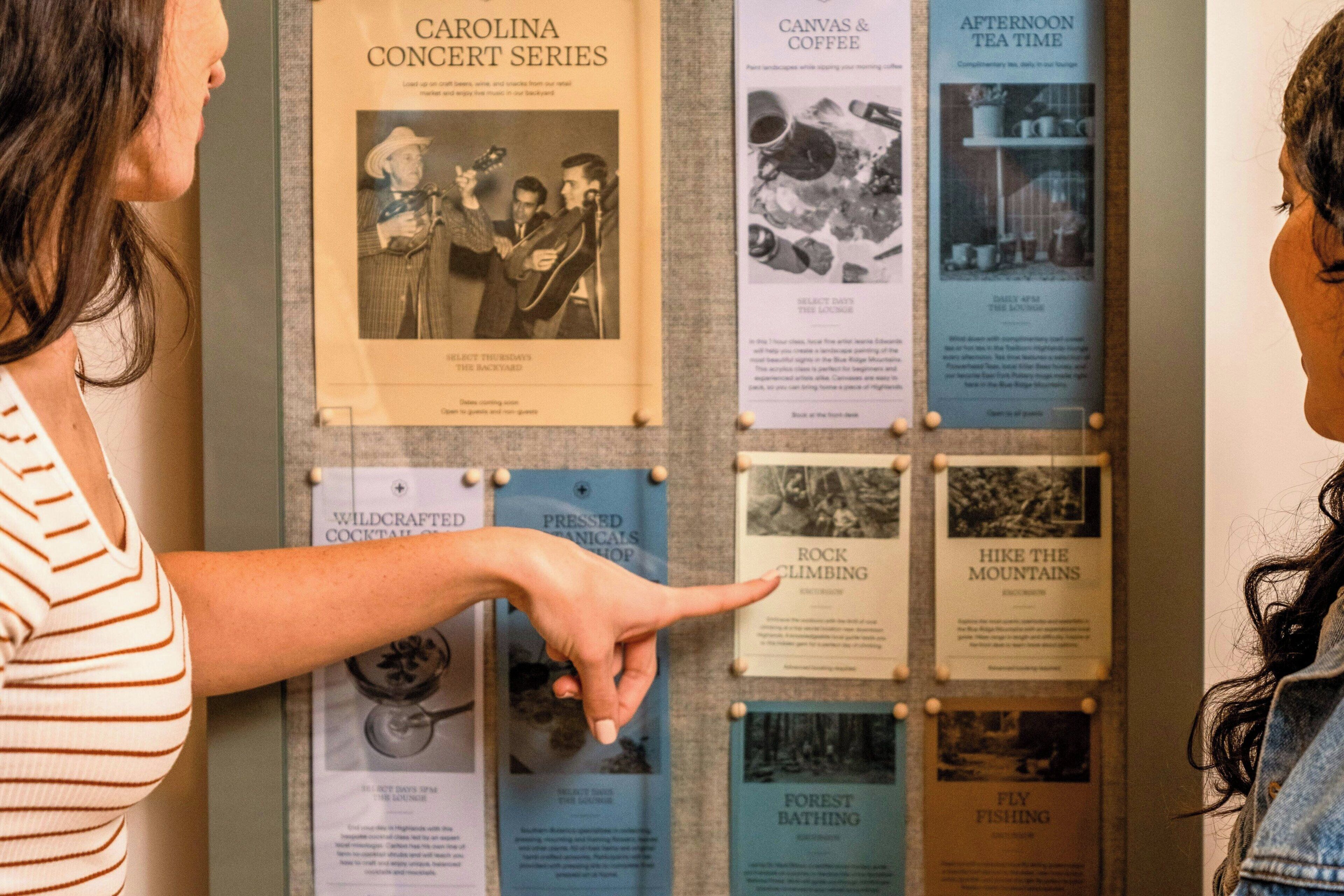 A bulletin board with various pinned items, including a Carolina Concert Series poster and other event-related materials.