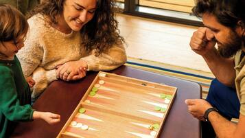A group of people playing a board game at a table.
