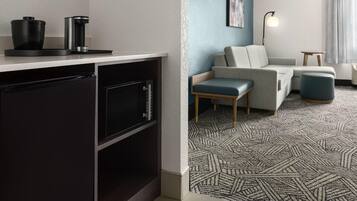 A modern kitchen with a dishwasher, a coffee maker, and a countertop.