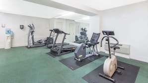 A gym with treadmills, an elliptical, and a stationary bike, equipped with mirrors and a water dispenser. - Days Inn by Wyndham Arlington Pentagon (Arlington)