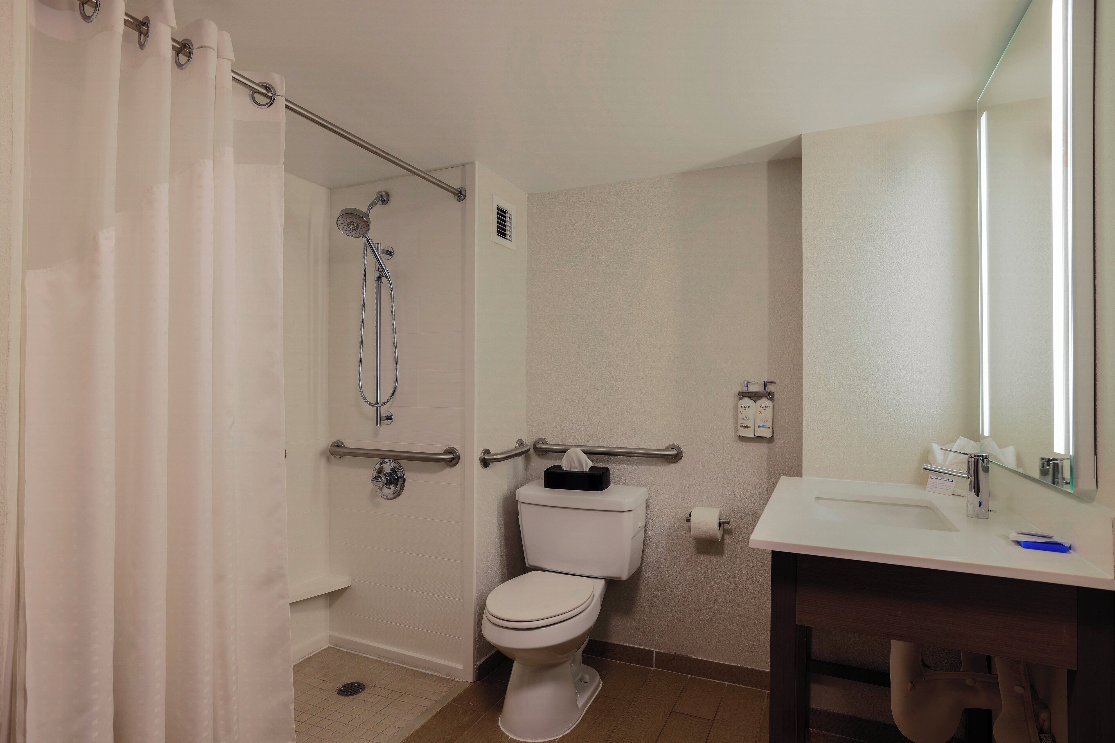 Un baño con ducha, inodoro y lavabo.