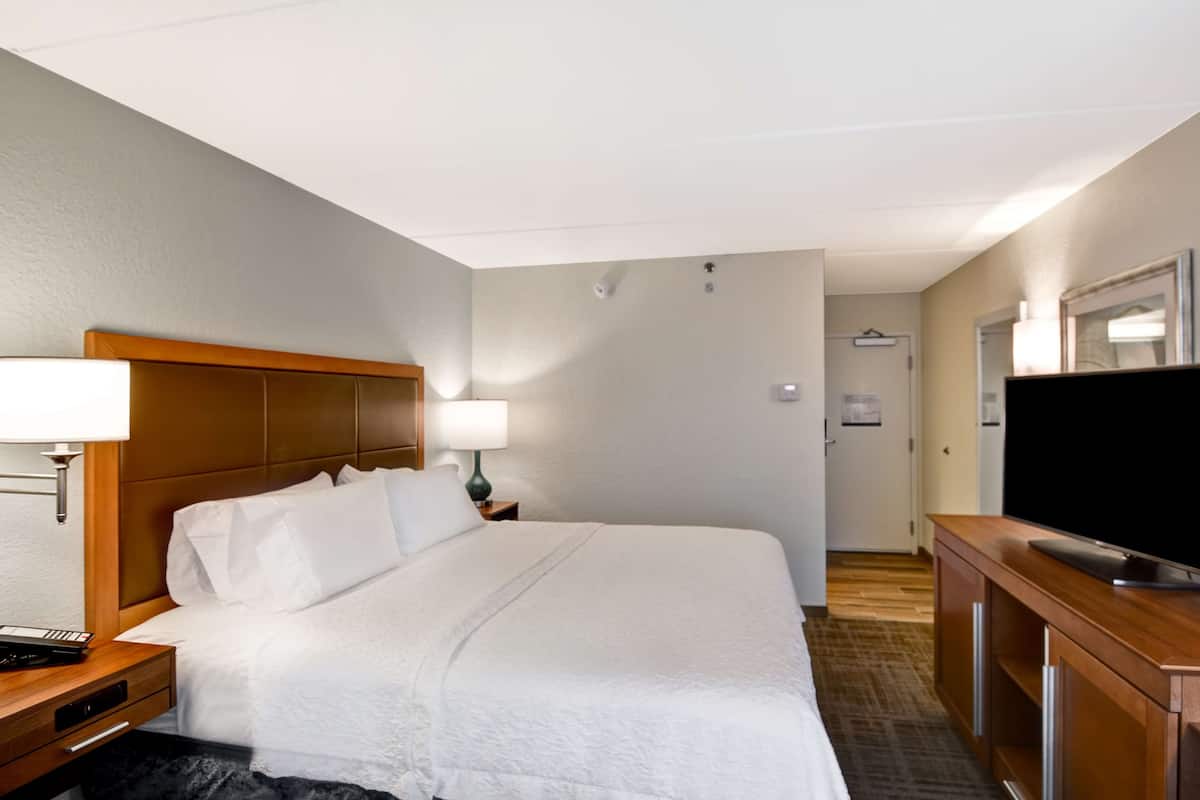 Premium bedding, desk, laptop workspace, blackout drapes