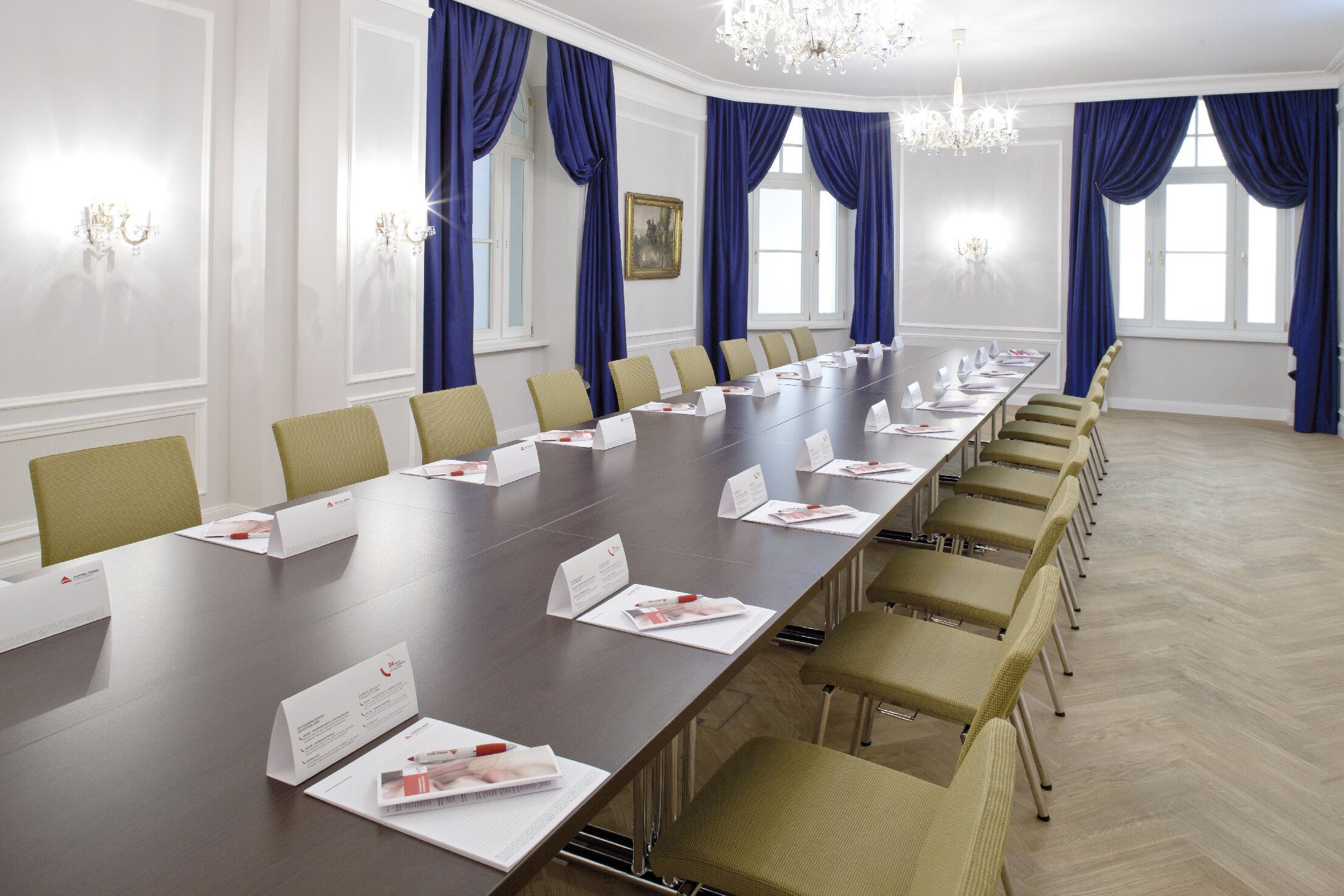 A conference room with a long table, name cards, and chairs.