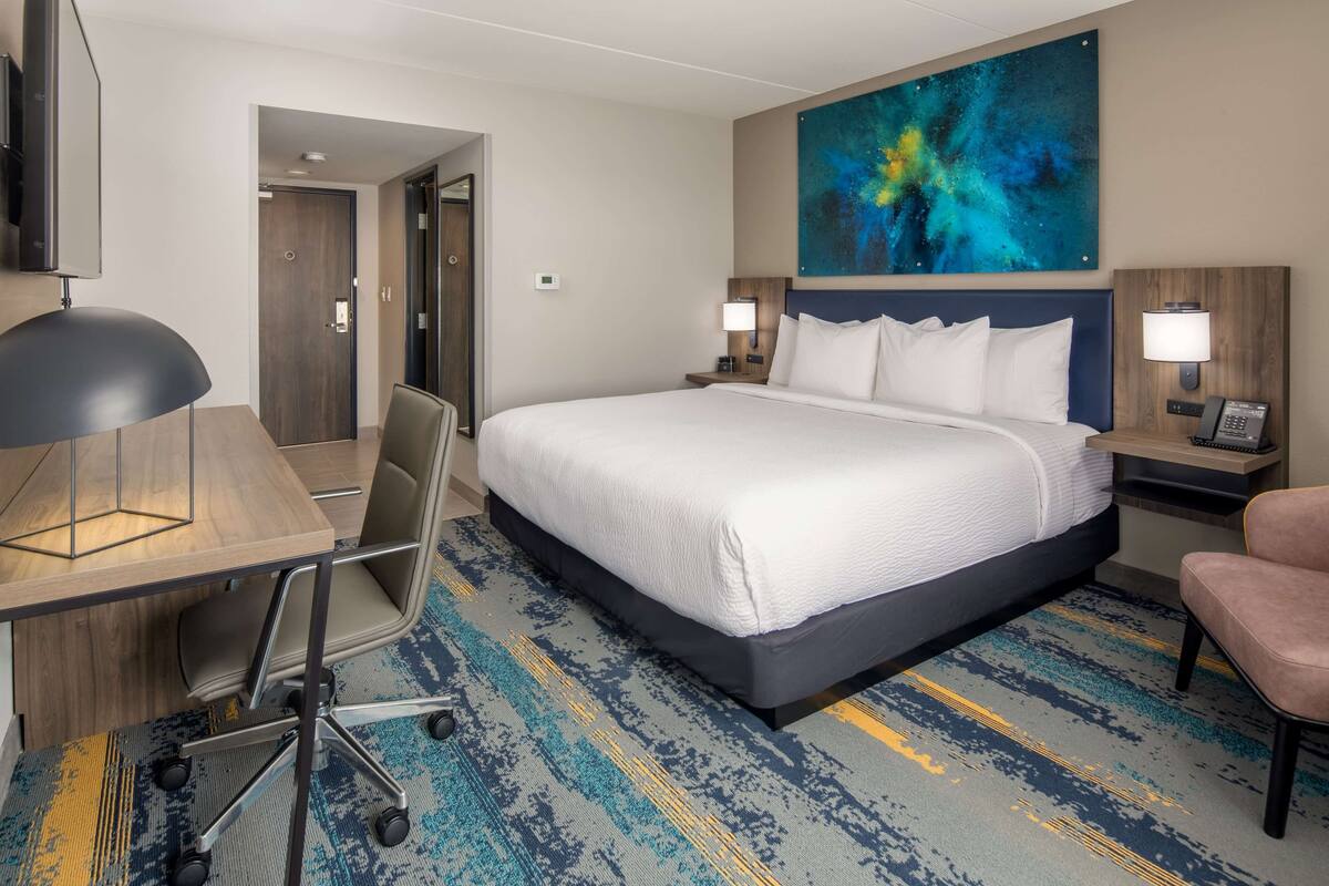 Premium bedding, desk, laptop workspace, blackout curtains